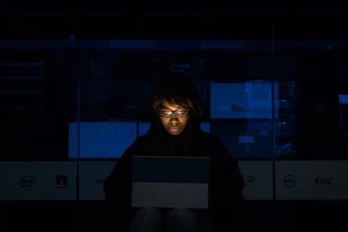 Person sitting in darkness